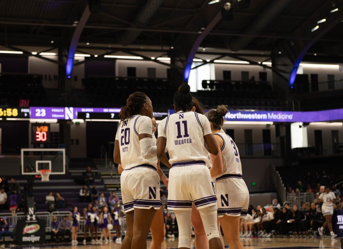 Northwestern Women’s Basketball team huddles after a foul is called.