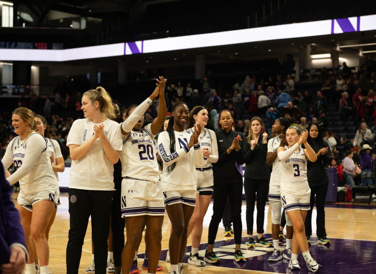 Northwestern Women’s Basketball team celebrates their win with the crowd.