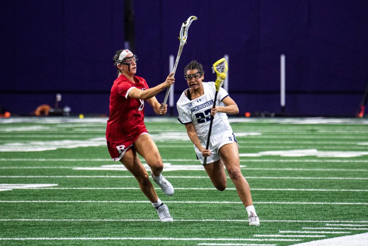 Junior defender Sammy White attempts to evade Rutgers midfielder Cassidy Spilis during Saturday night’s game. White made her return against the Scarlet Knights after missing six consecutive games with a lower-body injury.