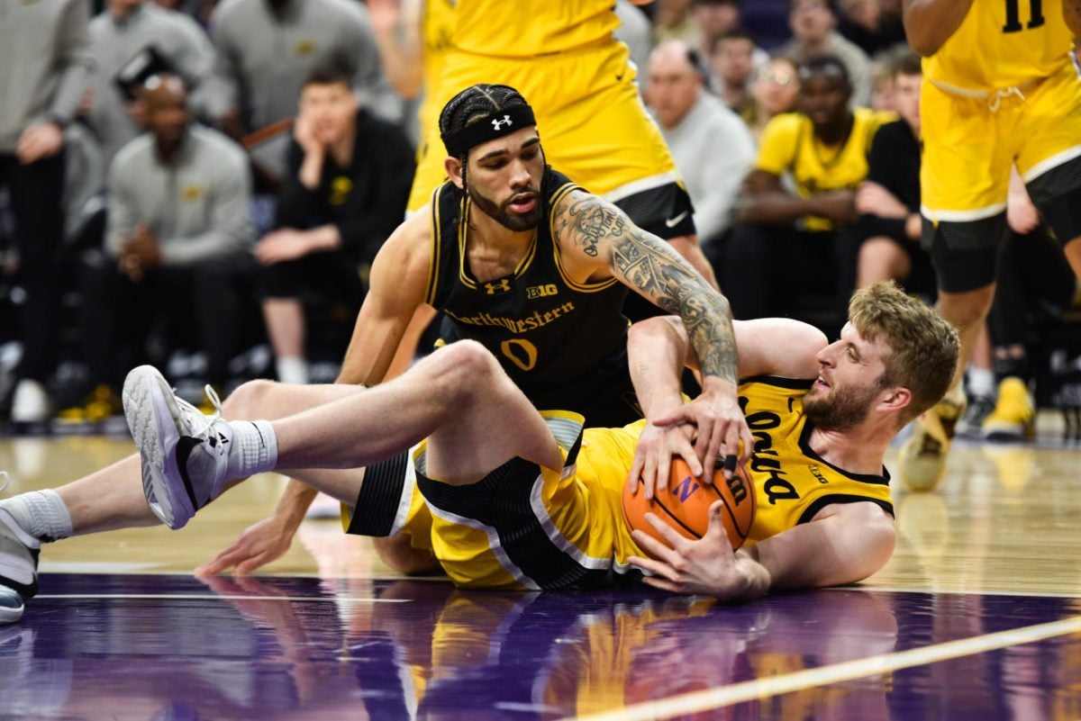  Graduate student guard Boo Buie attempts to tie up possession. In NU’s 87-80 loss to Iowa on Saturday, the Hawkeyes 51 second half points proved too costly. 