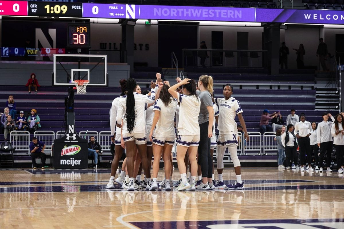 Northwestern huddles in a game against Ohio State