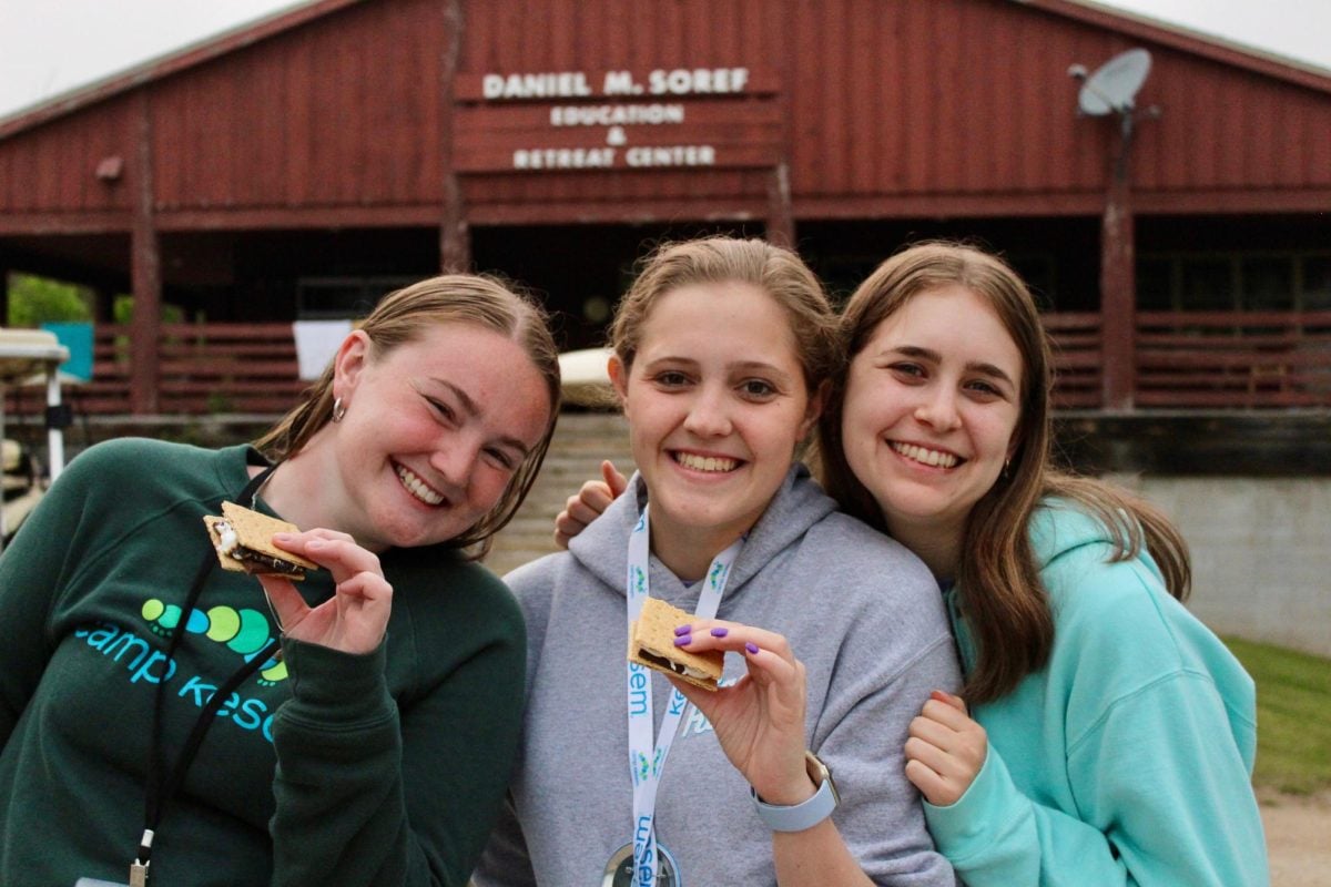 Camp Kesem counselors eat smores during camp in Wisconsin.
