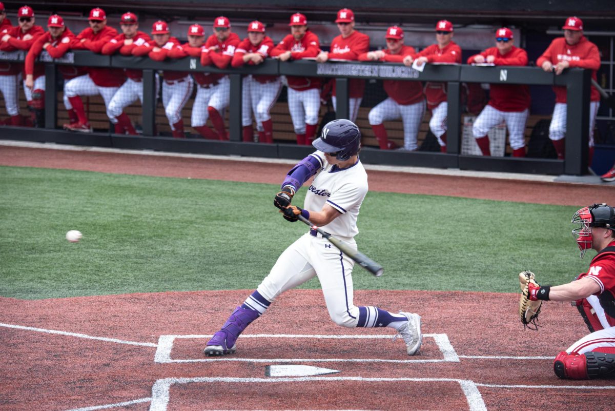 Northwestern outfielder Griffin Arnone swings his bat toward a pitch.