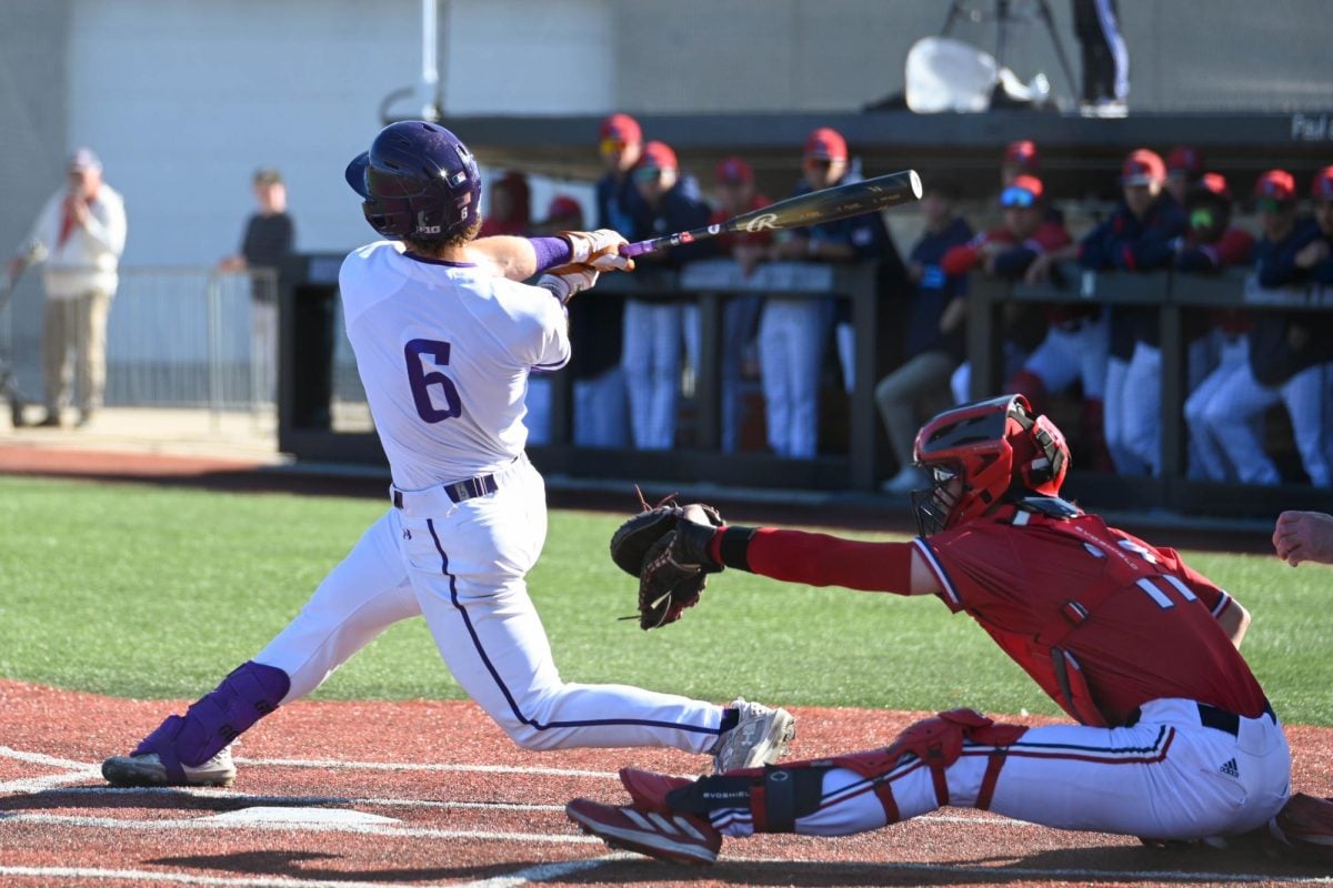 Graduate student Griffin Arnone swings at a pitch against UIC on Tuesday. Northwestern lost, 18-5.