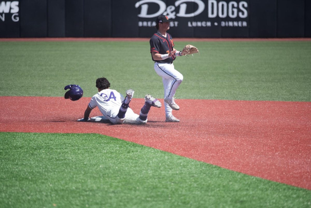 Lorenzo Rios’ helmet flies off in front of him as he slides into second.