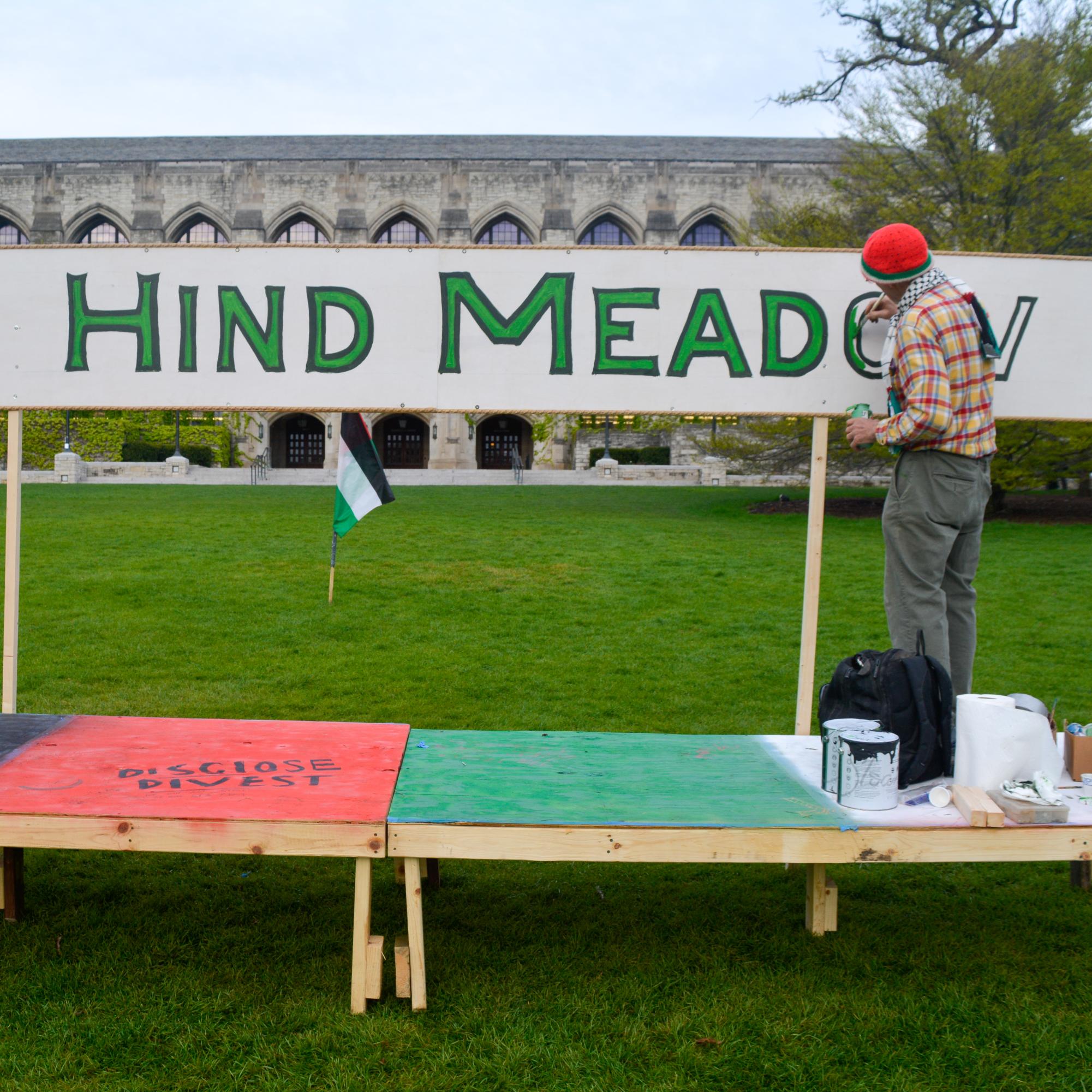 Evanston resident Dave Trippel began painting a sign Thursday afternoon that renames Deering Meadow Hind Meadow after Hind Rajab, a 6-year-old Palestinian child who was killed in January by Israeli tank fire in Gaza.