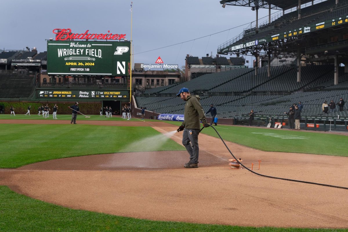The Wrigley Field grounds crew waters the field before the game.