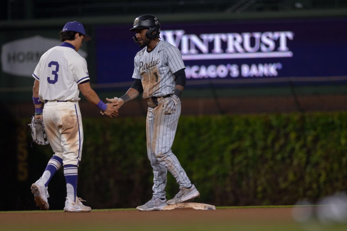 Purdue’s Mike Bolton Jr. and Northwestern senior infielder Tony Livermore high five at second base.