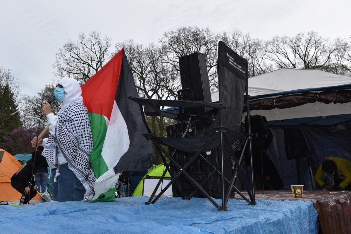 A demonstrator led the crowd in chants while waving a Palestinian flag.