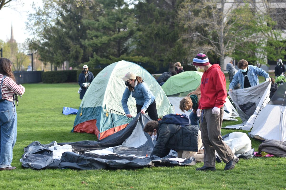 About 50 student activists began setting up an encampment on Deering Meadow Thursday morning.