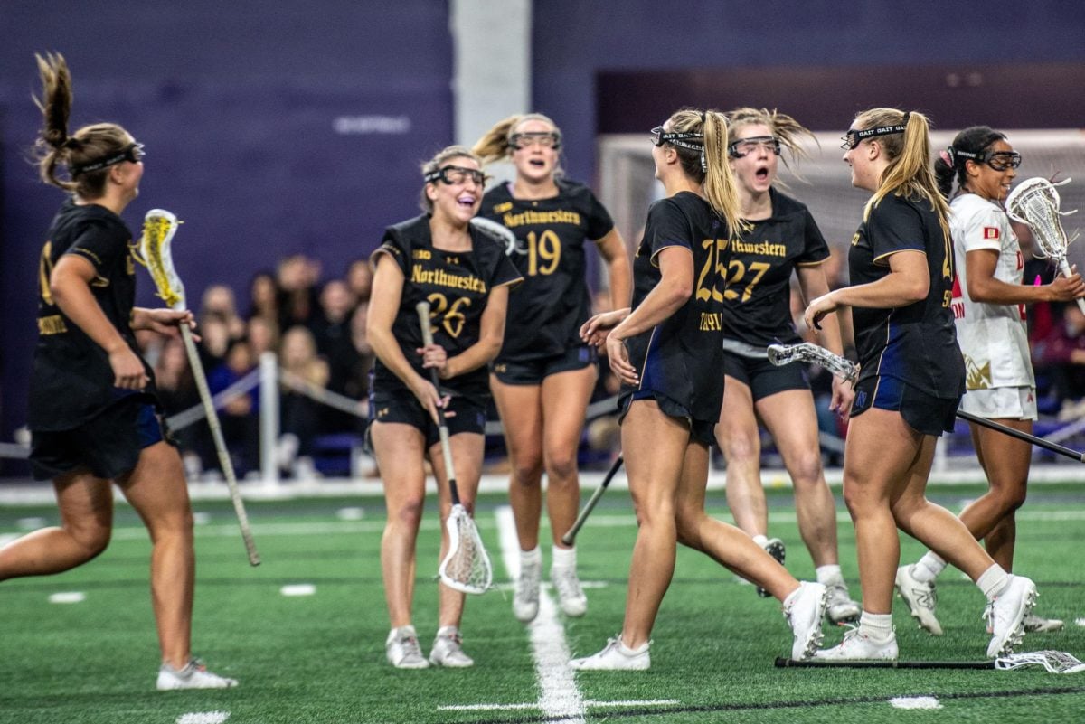 Northwestern players celebrate sophomore attacker Madison Taylor’s goal against Denver. Coach Kelly Amonte Hiller said she looks for players with an underdog mentality on the recruiting trail.