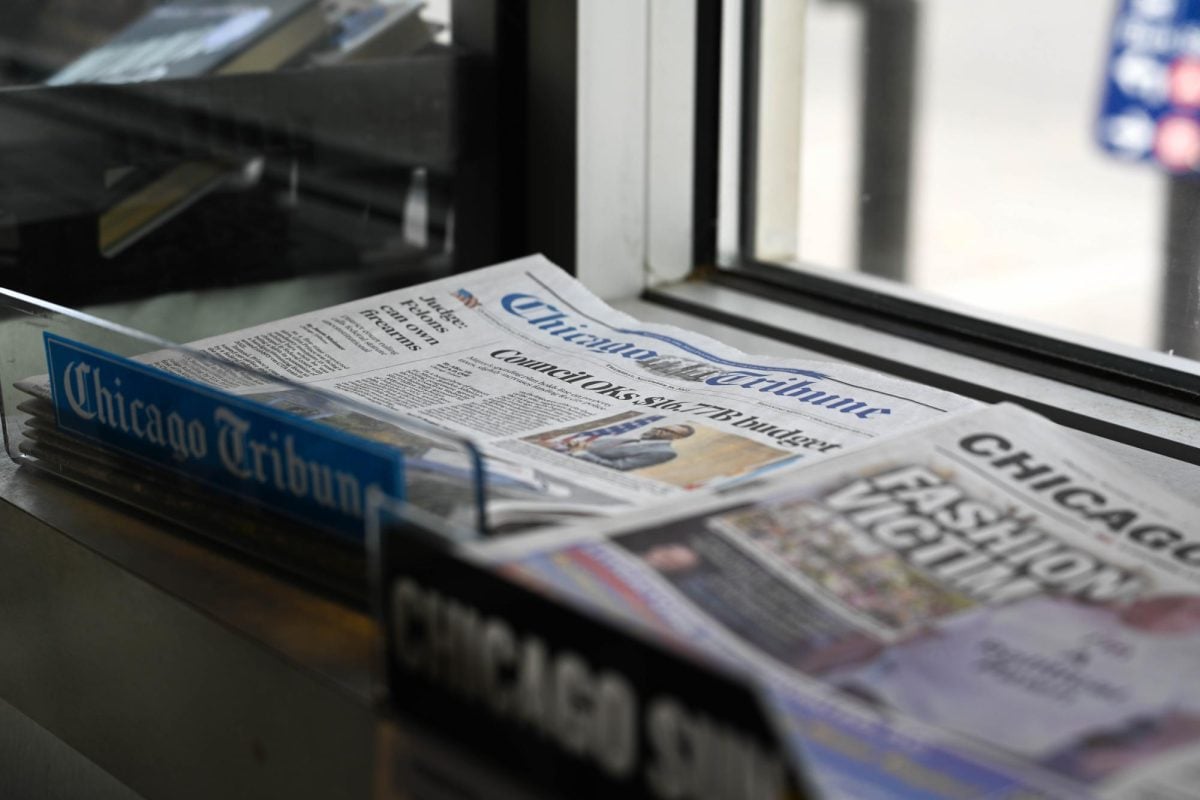 Newspapers lay on a counter.