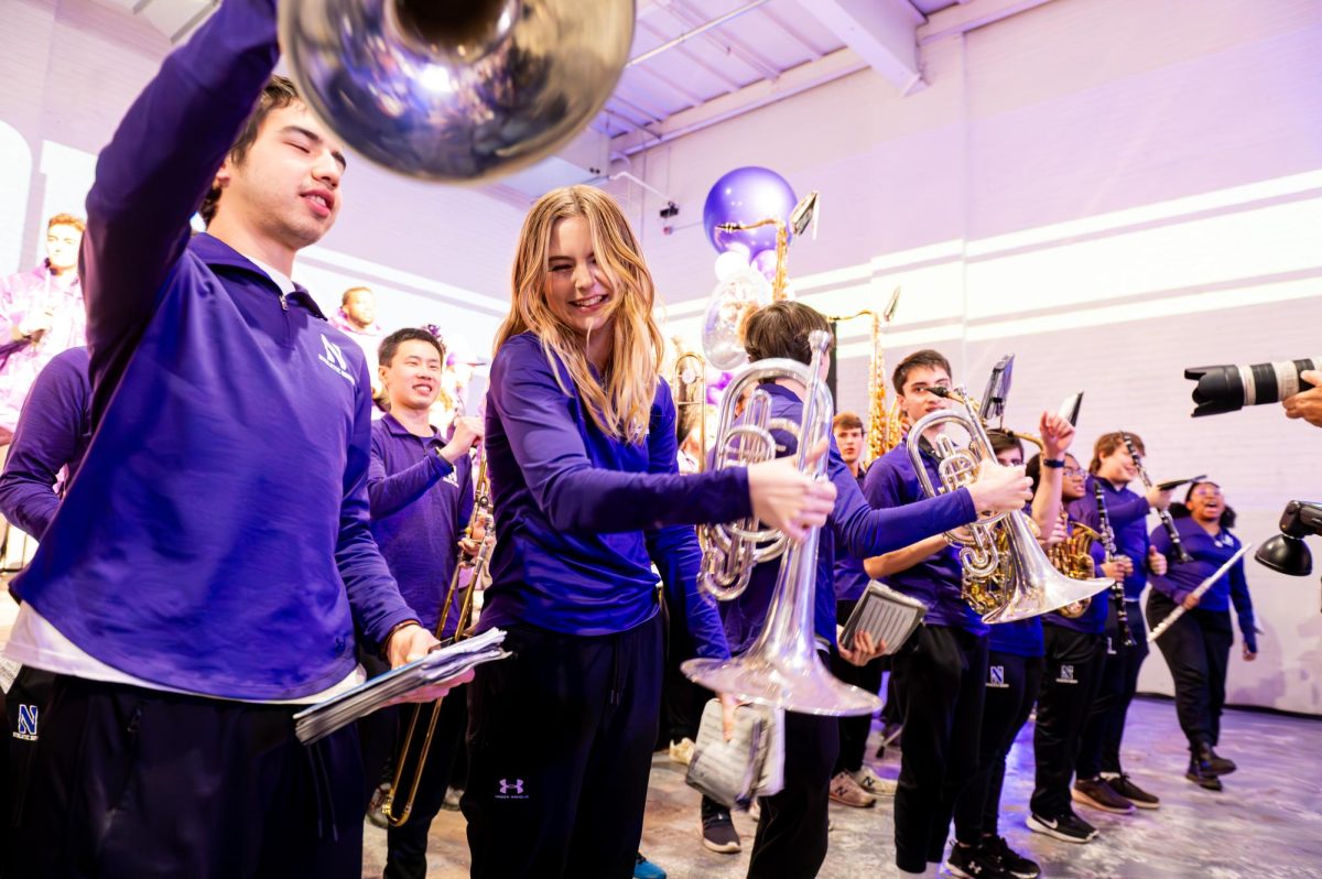 Members of the Northwestern University Basketball Band dance with their instruments.