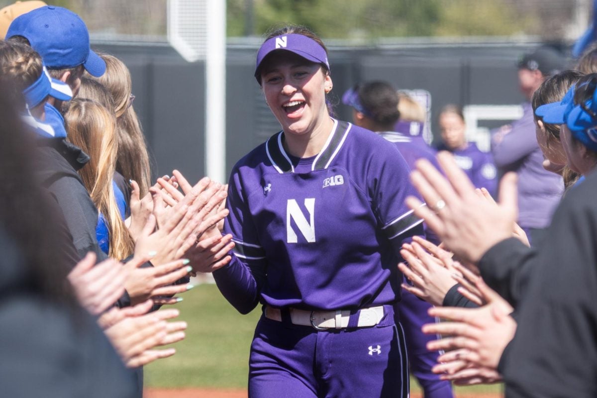  Freshman utility player Isabel Cunnea high-fives teammates before a game.