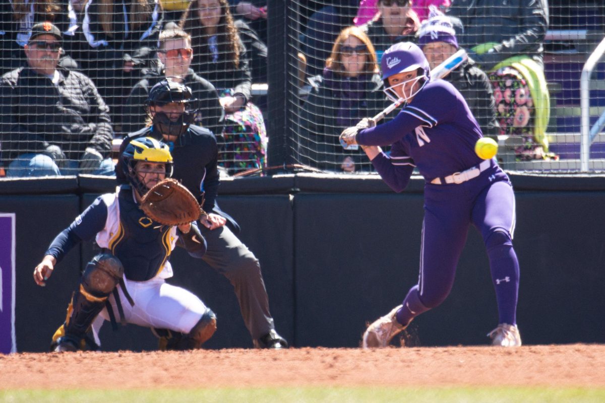 A Northwestern player prepares to swing at an incoming pitch.