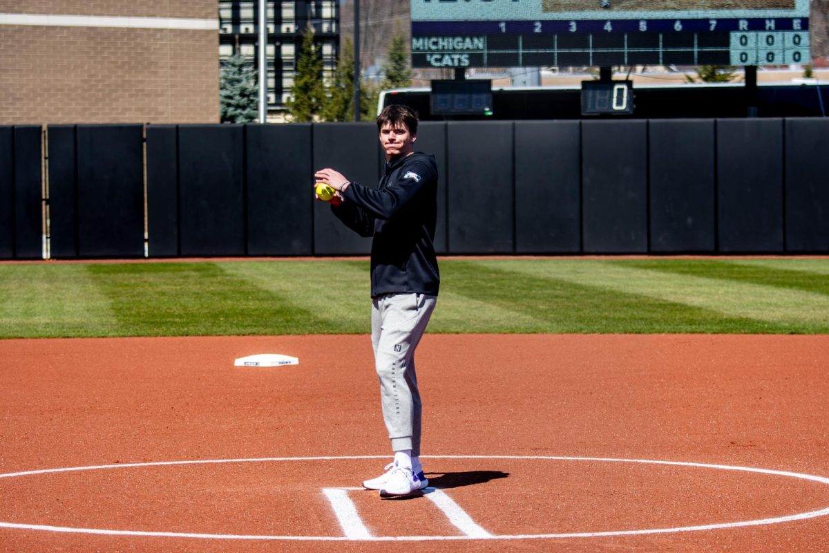 Men’s basketball player Brooks Barnhizer tosses the ceremonial first pitch.