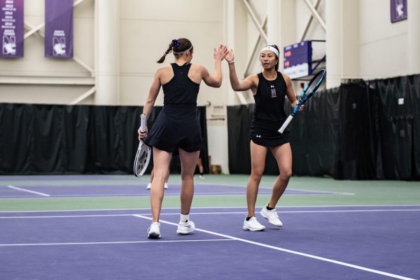 Senior Maria Shusharina and graduate student Britany Lau celebrate after winning a point. The duo went 2-0 this weekend and is 15-1 on the year.