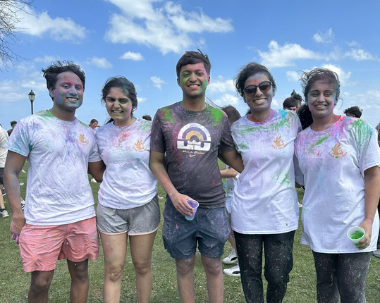 Attendees were covered in many colors while celebrating Holi.    
