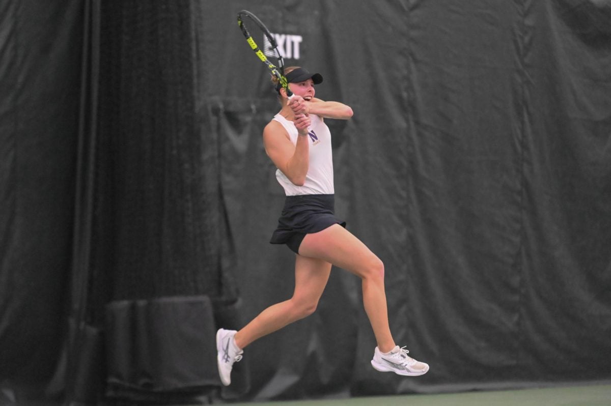 Northwestern junior Sydney Pratt leaps with a tennis racket in her hand