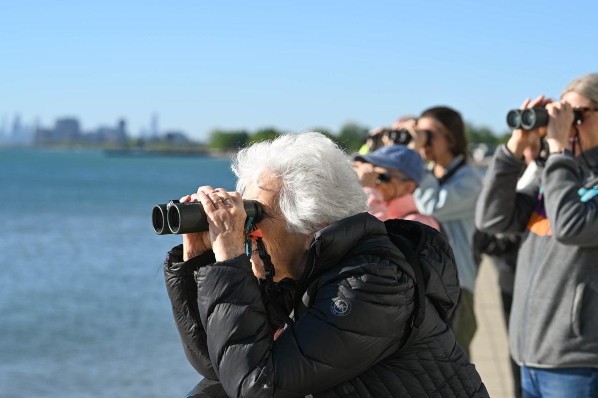 A person looks into binoculars.