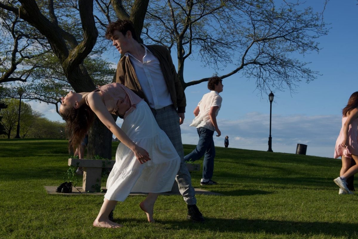 A person dips another person in a contemporary dance.