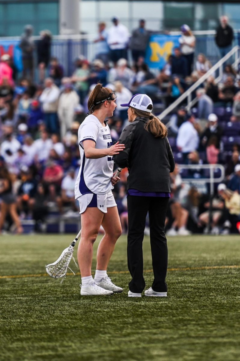 Graduate student attacker Izzy Scane and coach Kelly Amonte Hiller talk mid-game against Penn State. Scane and Amonte Hiller both took home individual honors Monday.