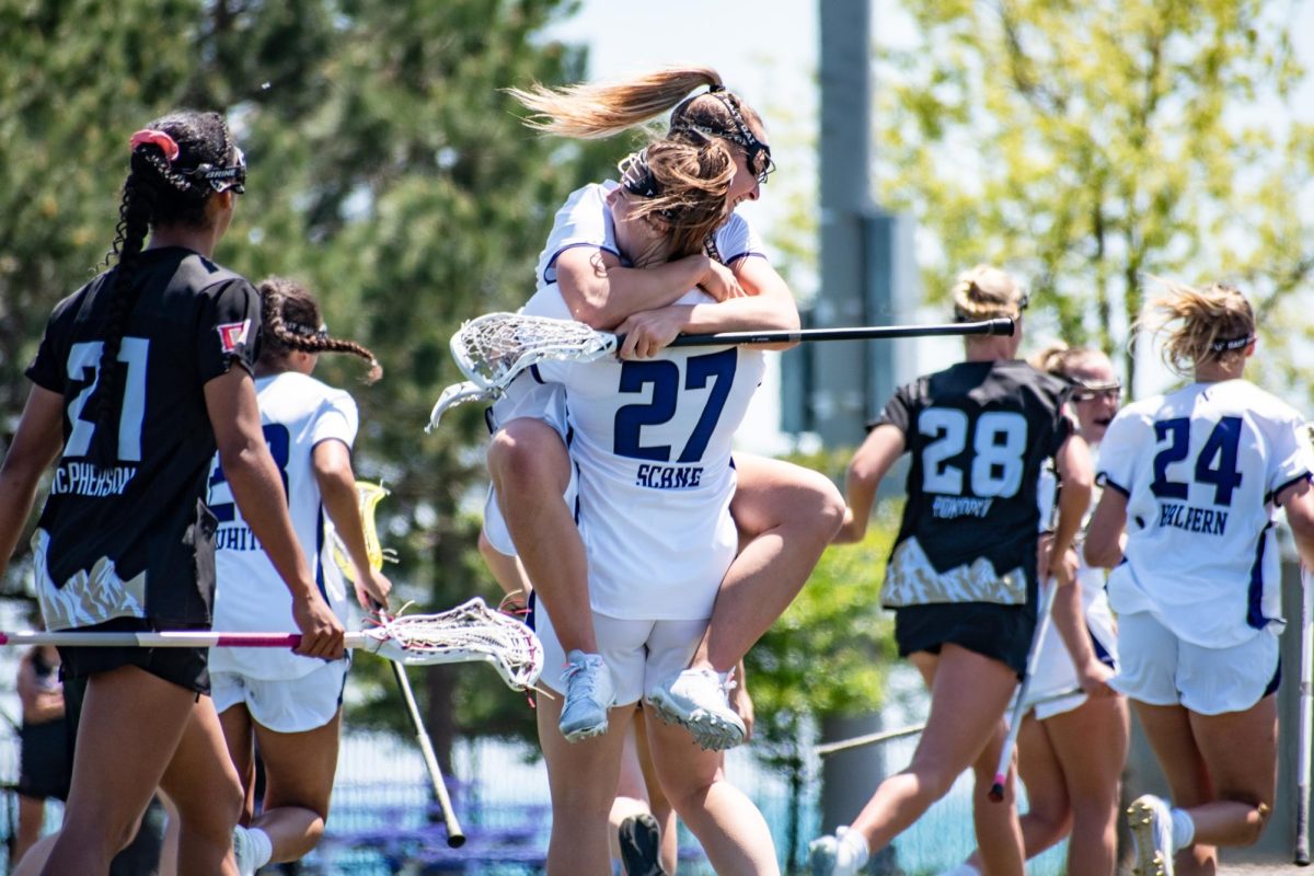Graduate student attacker Izzy Scane hugs sophomore attacker Madison Taylor after breaking the NCAA Division I career goals record against Denver Sunday afternoon.