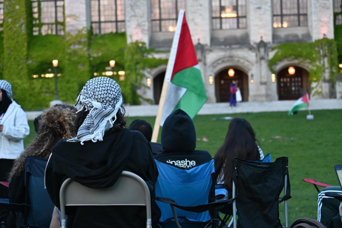 Attendees in lawn chairs face Deering Library during the Nakba Remembrance Vigil.