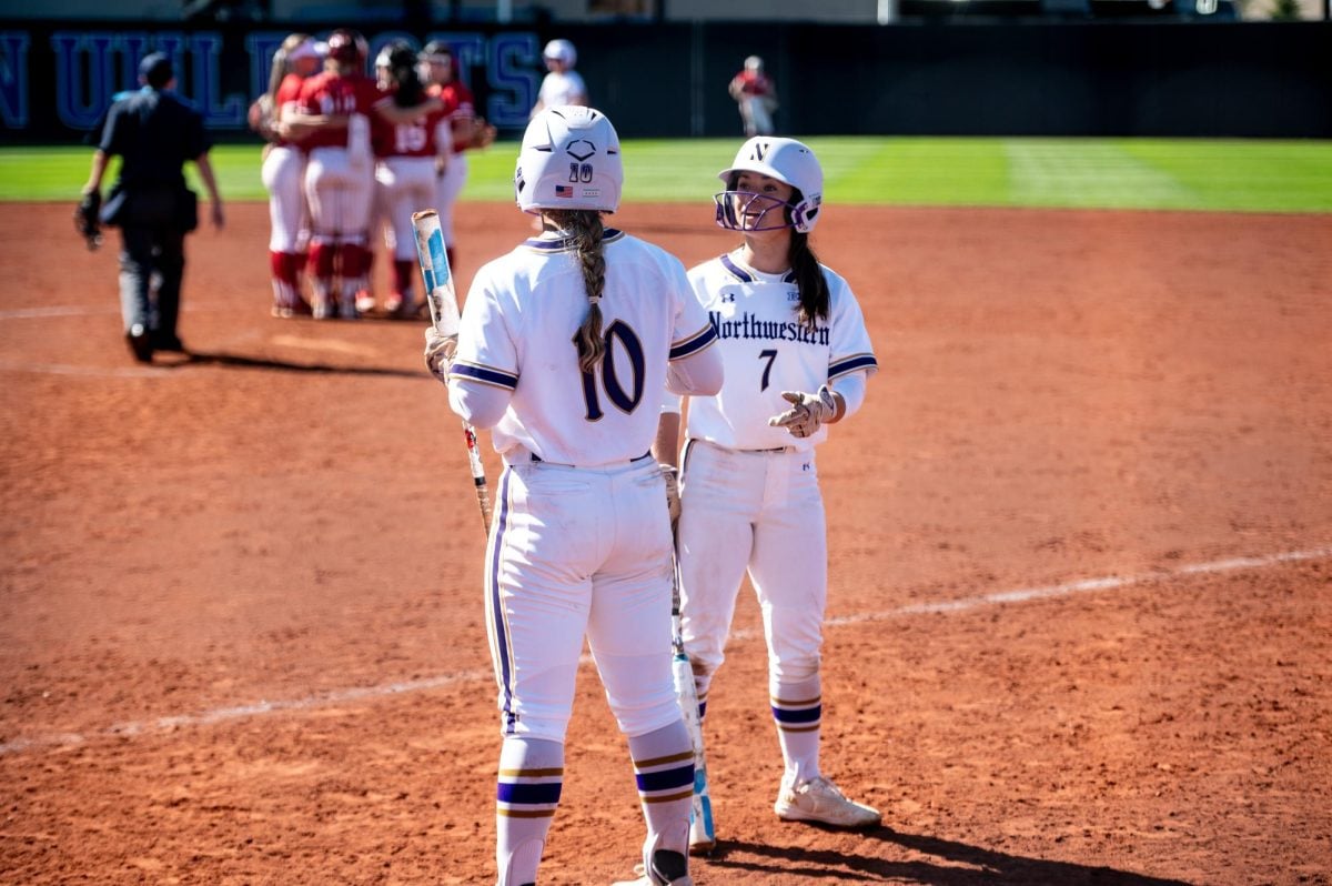 Sophomores Kansas Robinson and Kelsey Nader discuss strategy between at-bats.