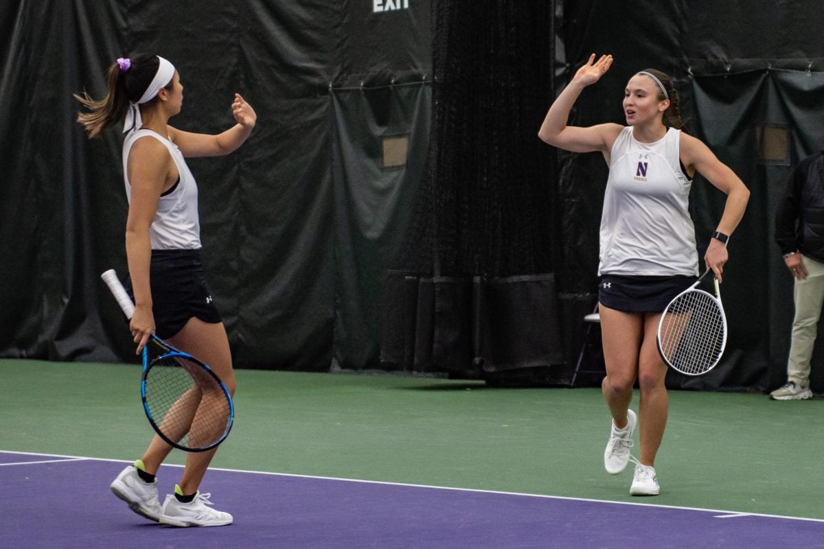  Graduate student Britnay Lau and senior Maria Shusharina celebrate after winning a point. They won their match on Friday 6-4.
