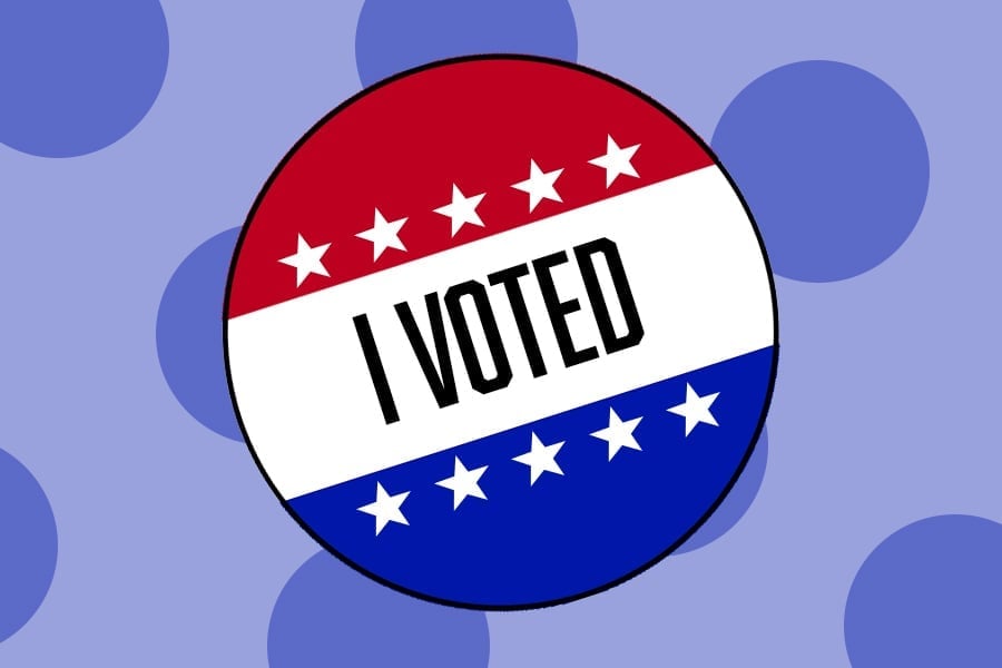 An+%E2%80%9CI+Voted%E2%80%9D+sticker+on+a+purple+polka+dot+background.