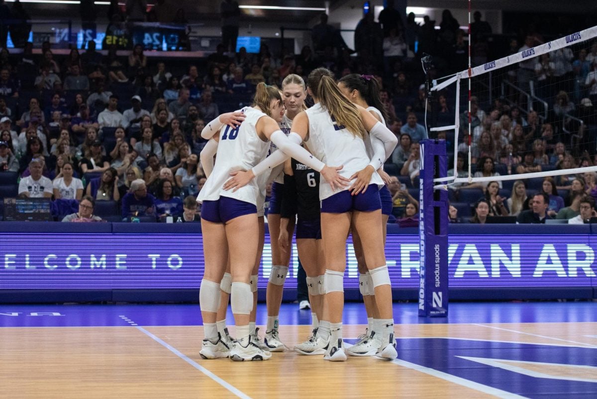 The team huddles during a match against Penn State last season. Graduate student Alexa Rousseau and junior Kennedy Hill represented the players at Big Ten Media Days Monday. 