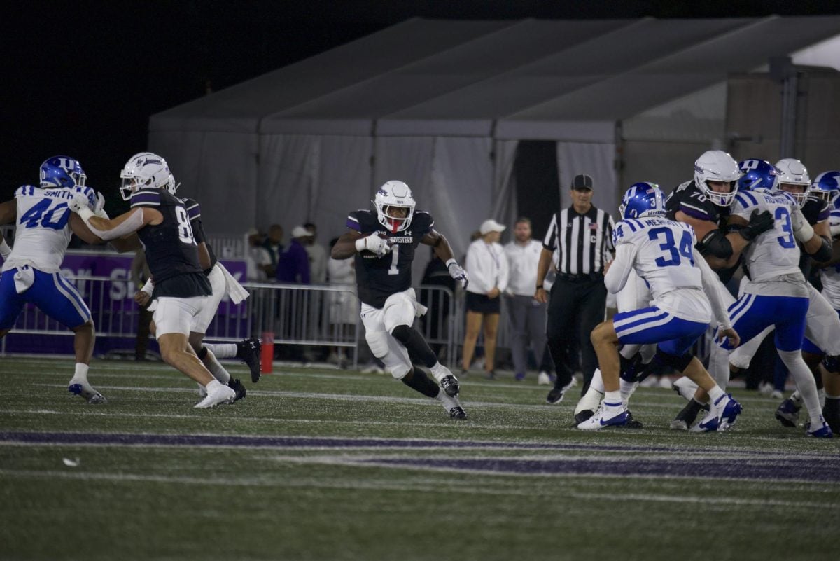 Graduate student running back Cam Porter rushes against Duke. 