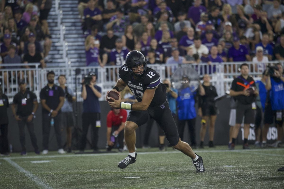 Redshirt sophomore quarterback Jack Lausch scrambles against Eastern Illinois Saturday night. Lausch threw his first two collegiate touchdown passes in the victory.