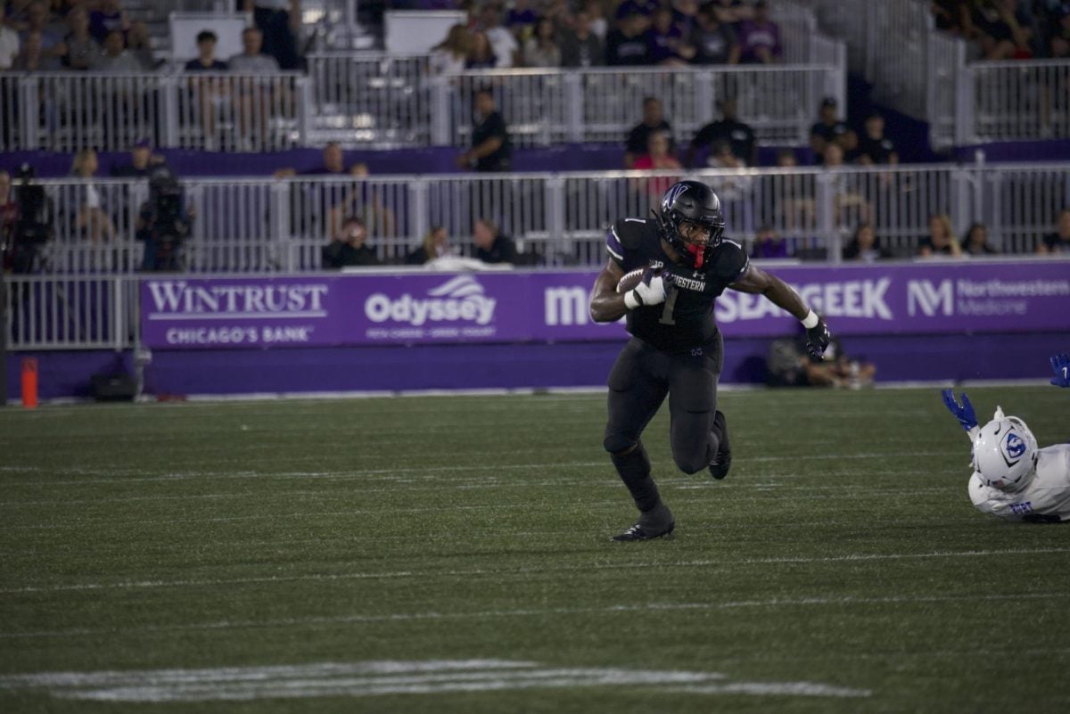 Graduate student running back Cam Porter carries the ball against Eastern Illinois Saturday night. 