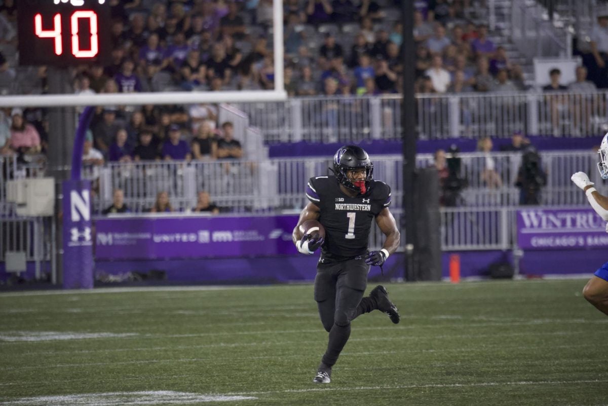 Graduate student running back Cam Porter carries the ball against Eastern Illinois Sept. 14.