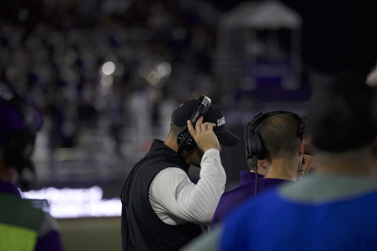 Coach David Braun looks toward the field during Northwestern's game against Eastern Illinois.