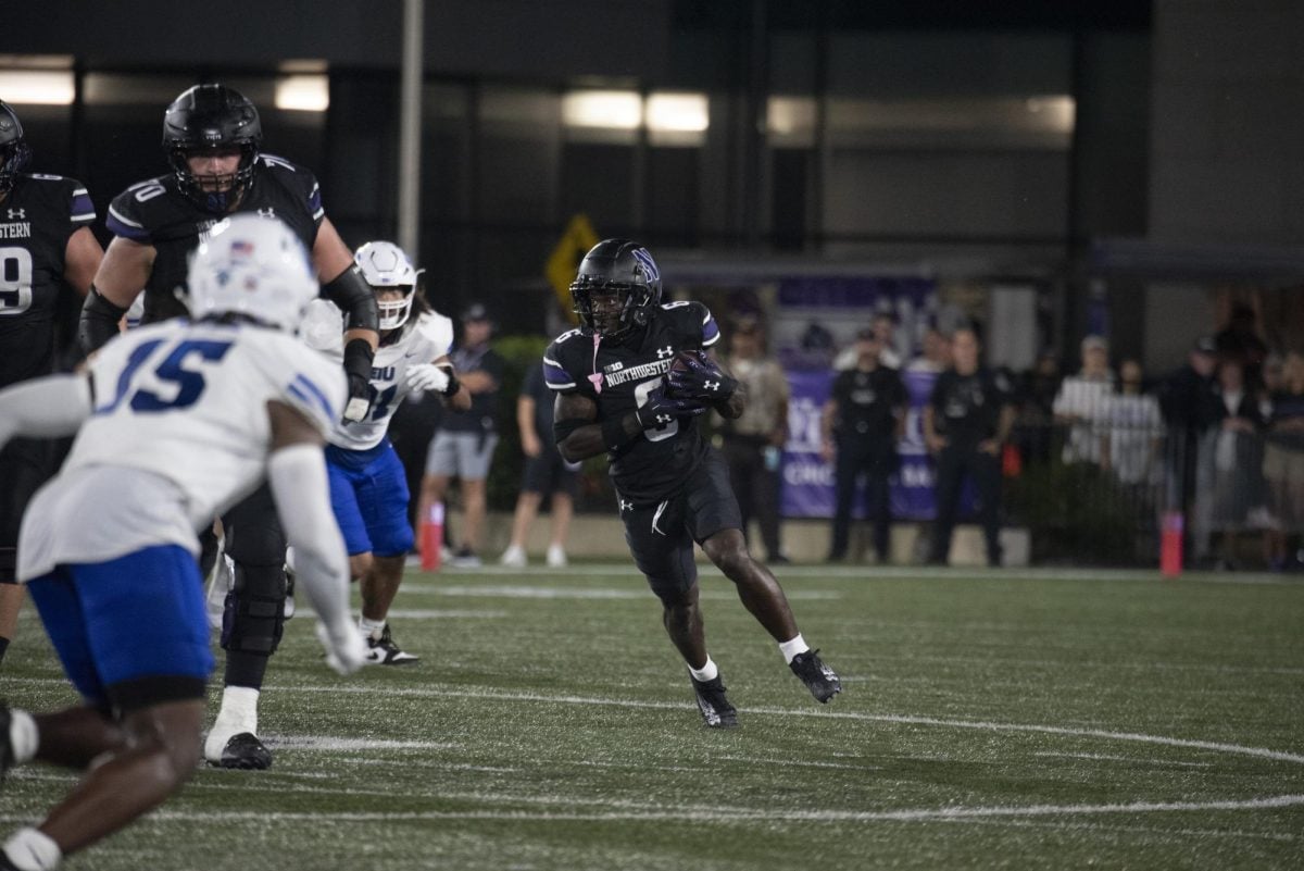 Redshirt sophomore running back Joseph Himon II evades tackles against Eastern Illinois Saturday night. Himon scored his first touchdown in more than a year against the Panthers.