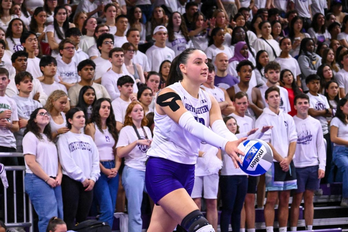 Sophomore outside hitter Lily Wagner prepares a serve. Wagner tied for a team-high six kills in Northwestern’s loss to Wisconsin Saturday. 