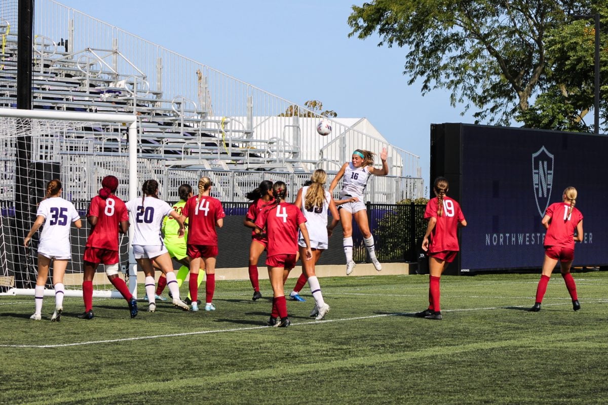 Senior defender Emma Phillips heads the ball toward the net during a set piece play against Harvard Sunday.