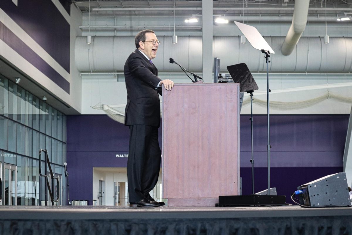 University President Michael Schill addresses a crowd at Parent &amp; Family Orientation 2024. His base salary appears to be in line with that of other elite private university leaders, according to public tax filings.