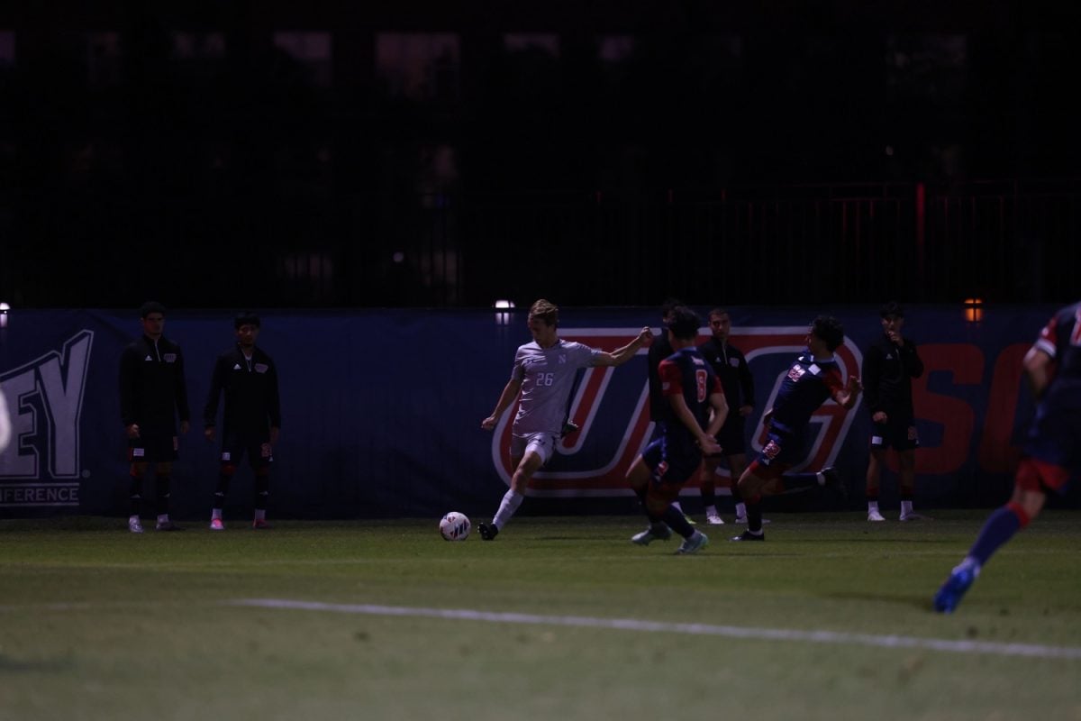 Sophomore defender Bryant Mayer whips in a cross against UIC Monday night. Mayer recorded his second assist of the season in the victory.