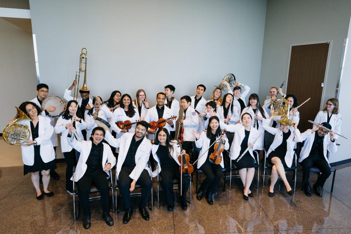 Members of the Northwestern Medical Orchestra holding their instruments