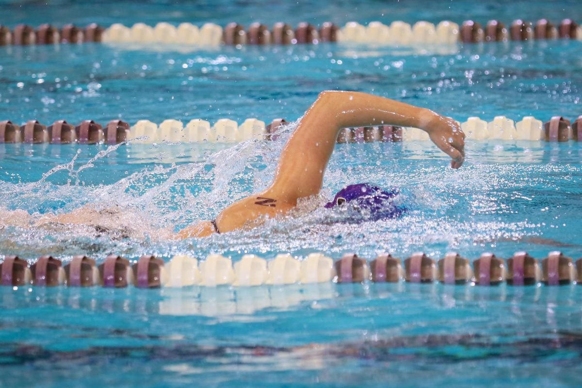 A Northwestern swimmer participates in the freestyle event.