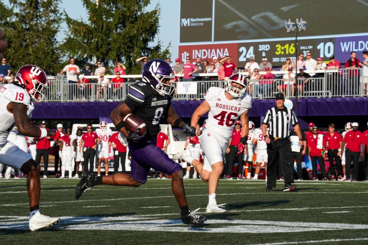 Graduate student wide receiver A.J. Henning darts toward the endzone for the first of his two touchdown grabs against No. 23 Indiana Saturday.