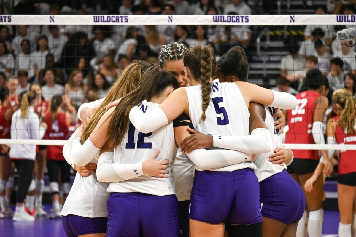 Northwestern huddles during last week’s match. The Wildcats lost to the Boilermakers in four sets Friday. 