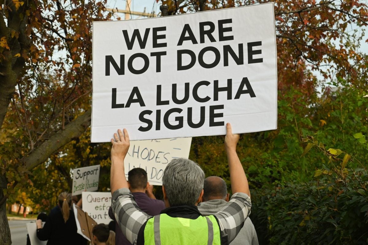 Families have been protesting the district’s June decision to close down the school after this academic year for the past few months. Some signs the protesters carried featured messages in both English and Spanish; “la lucha sigue” translates to “the struggle continues.”