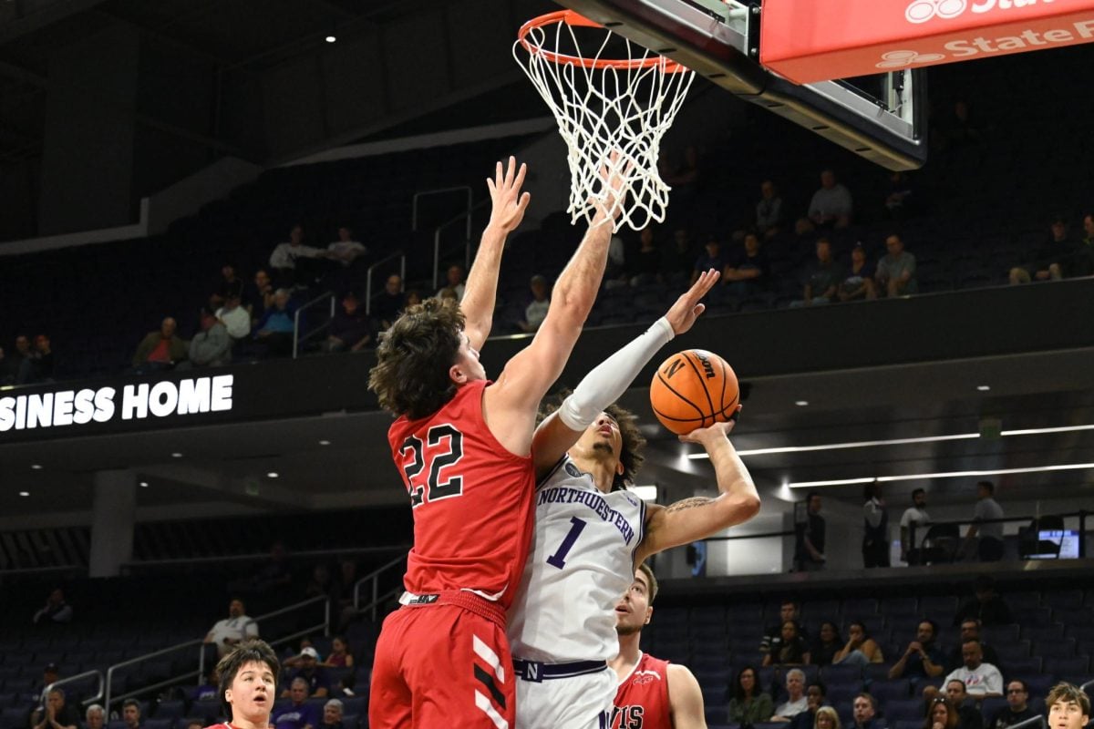 Graduate student guard Jalen Leach drives to the basket against Lewis Wednesday. Leach scored 20 points in the exhibition game.