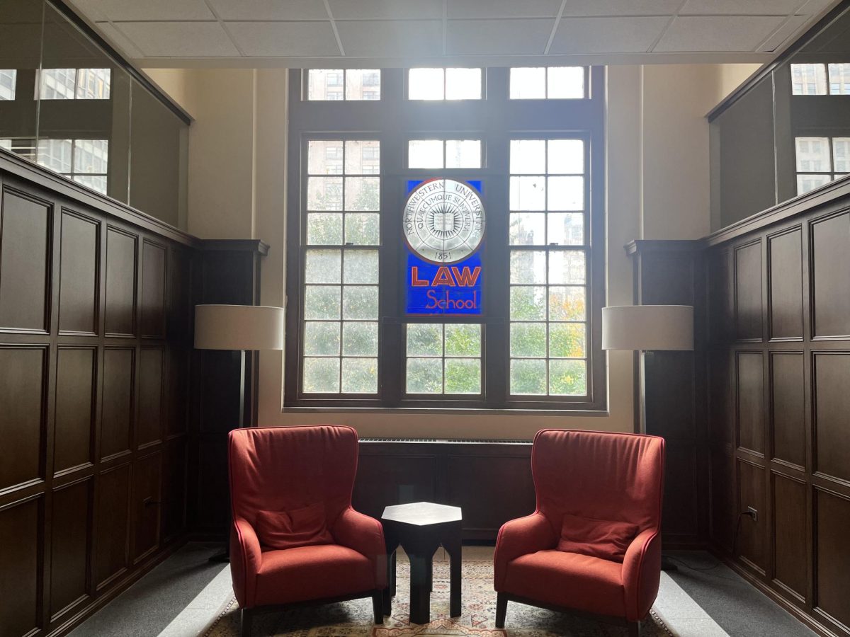 Stained glass with the law school logo inside Pritzker School of Law