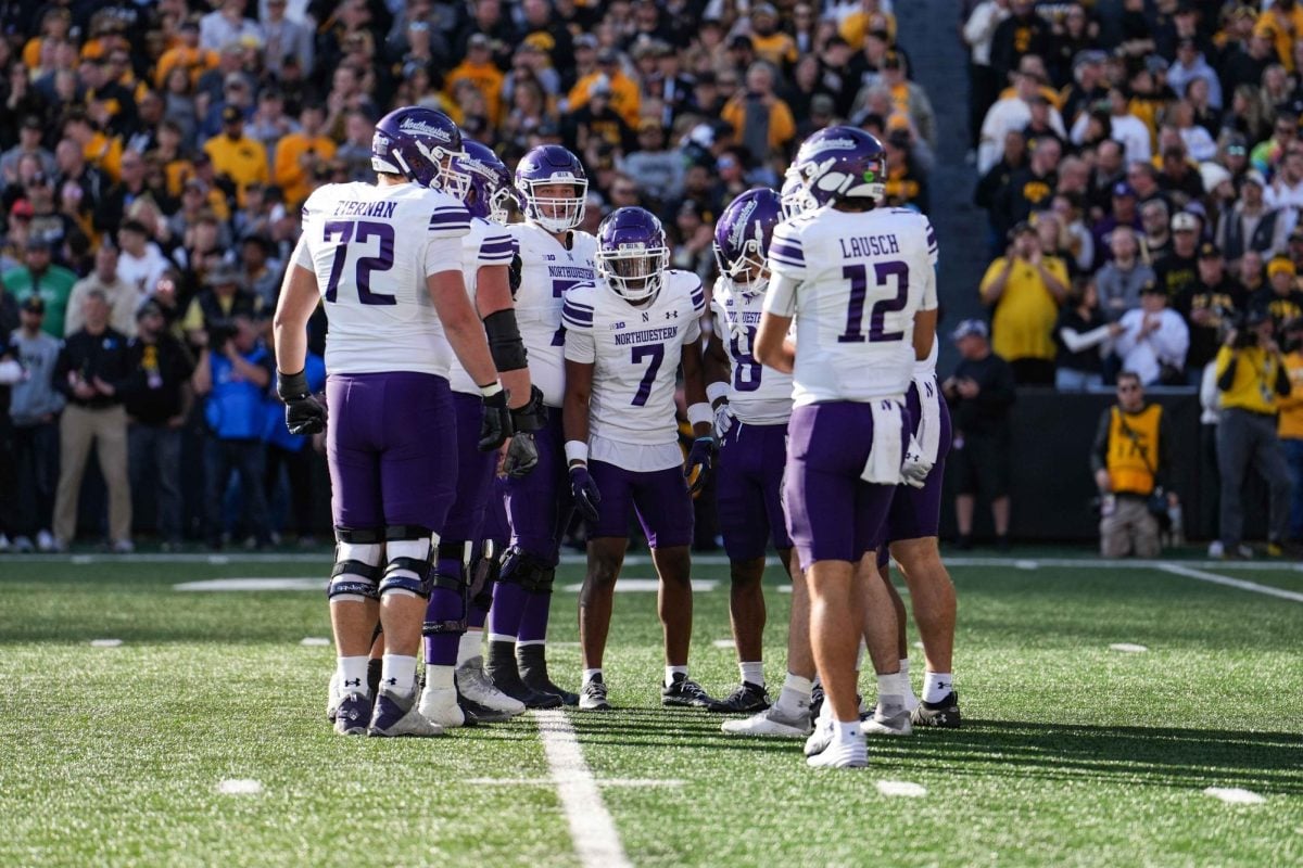 Northwestern huddles ahead of an offensive snap against Iowa Saturday.